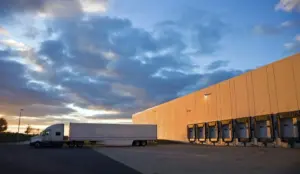 Truck trailer at warehouse loading dock for fleet rental logistics