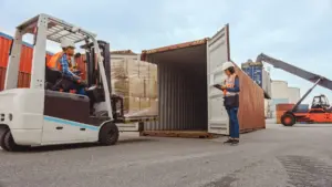 A forklift filling manufactured goods to a truck