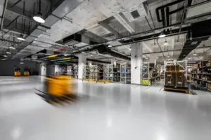 A forklift in a warehouse transporting manufactured goods