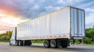 A truck on a highway transporting manufactured goods