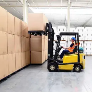 A forklift operator is stacking cargo in the warehouse.